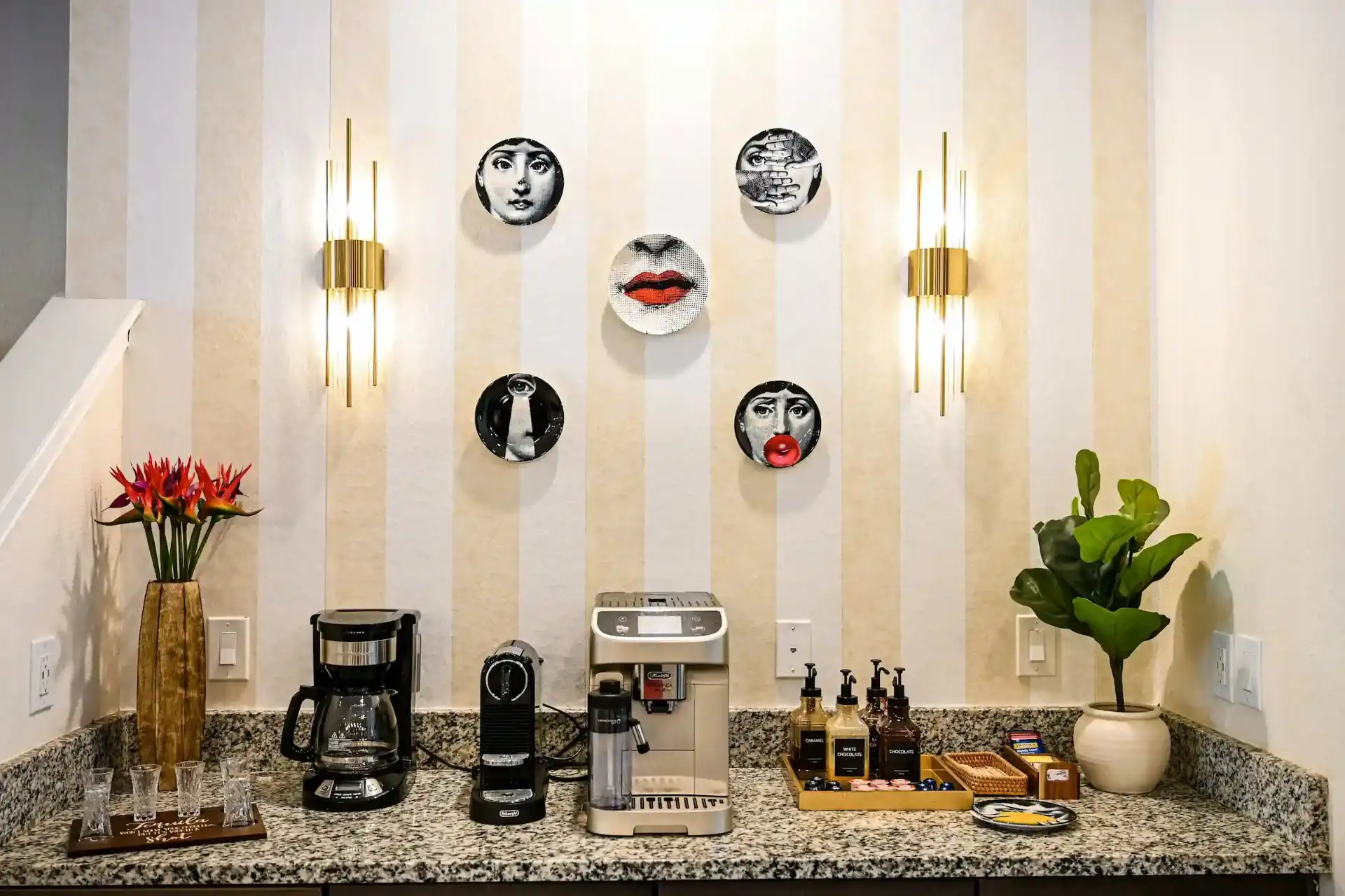 Coffee bar with espresso machines and Fornasetti plates
