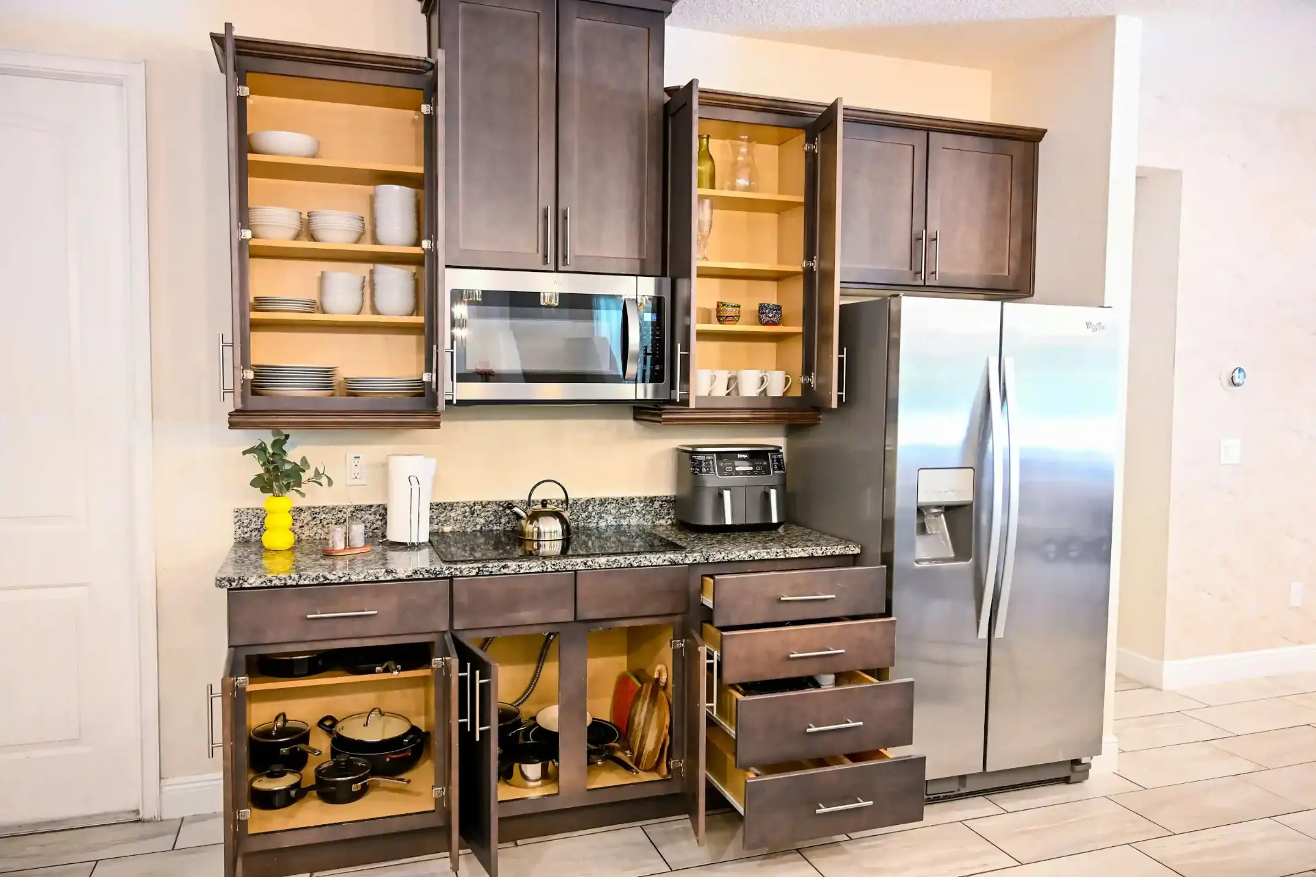 Fully stocked cabinets with dishware and cookware