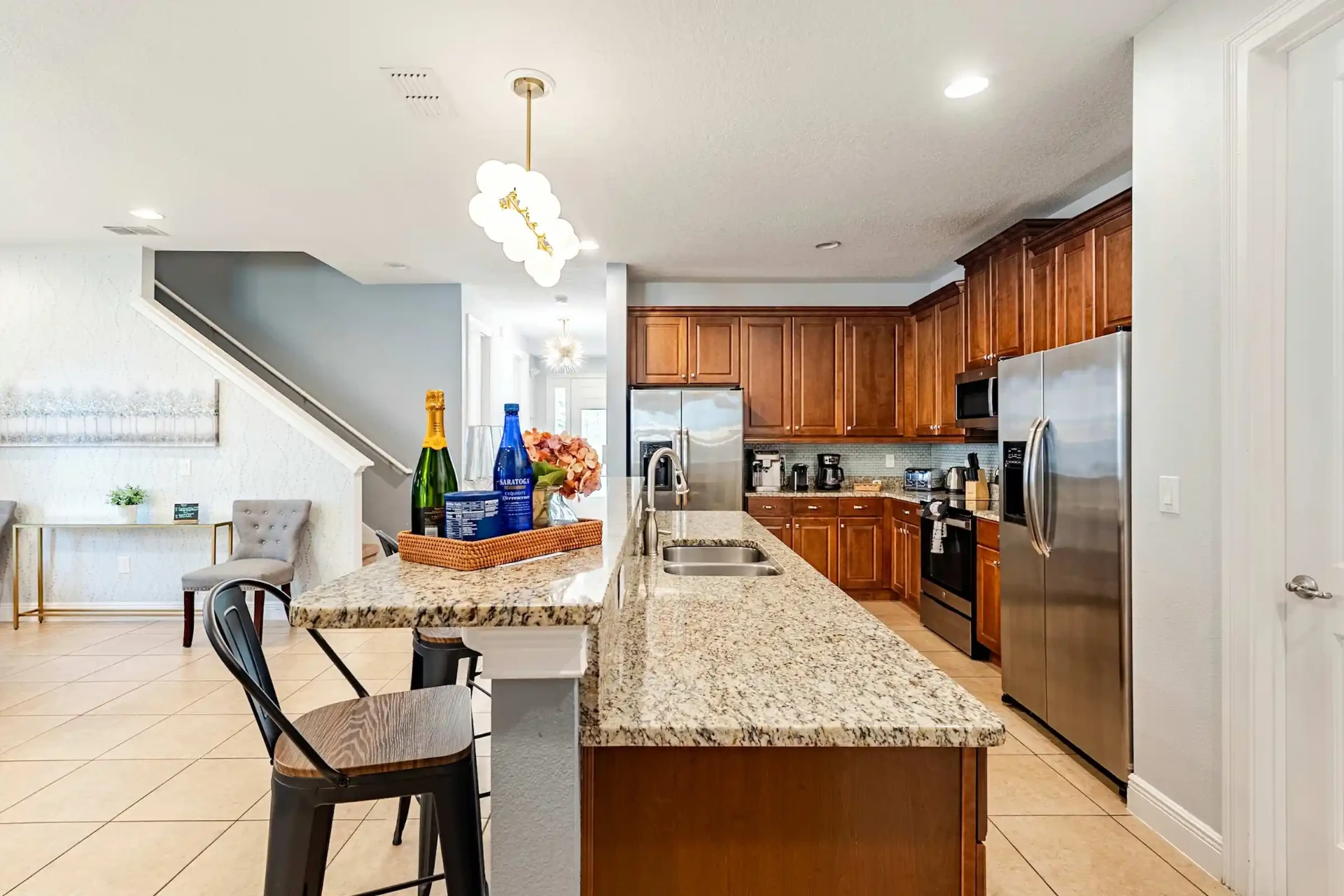 Granite island kitchen with sink and stainless steel appliances