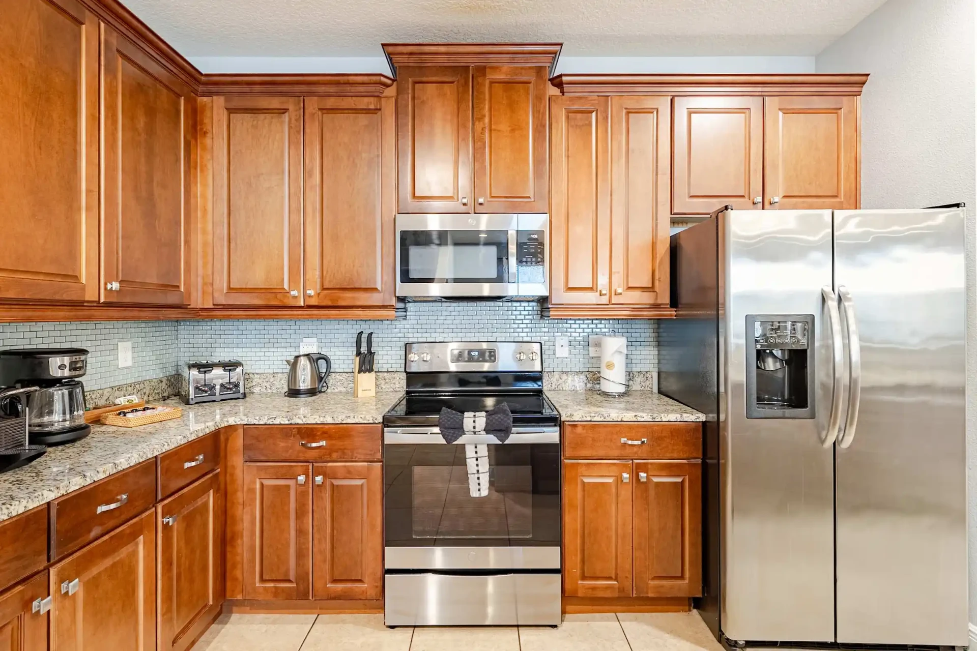Fully equipped kitchen with range, microwave and wood cabinetry