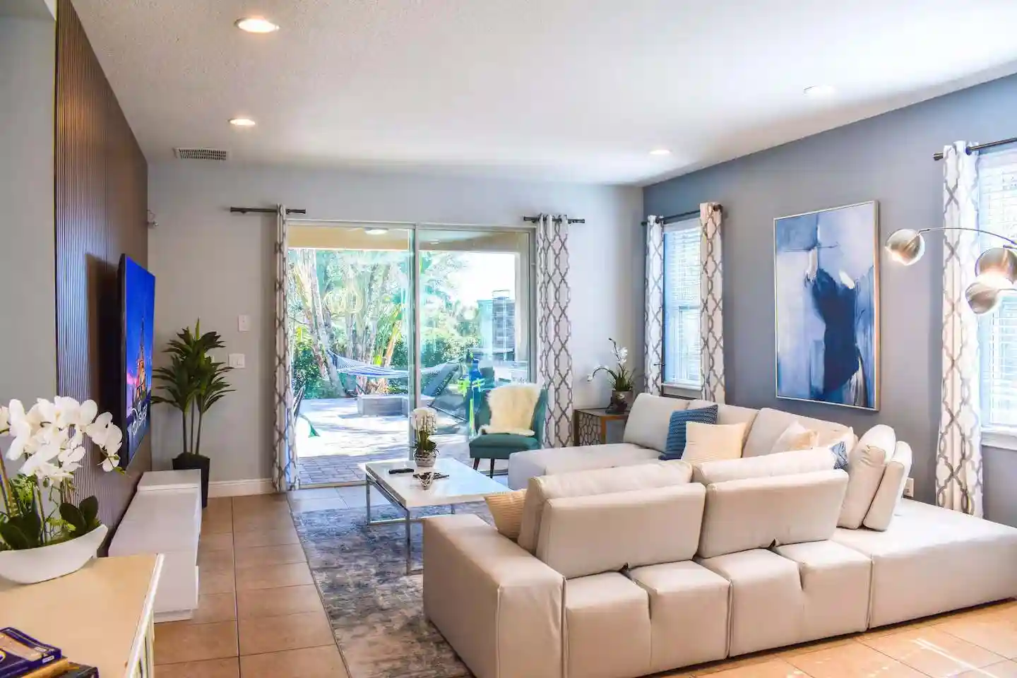 Lounge area with modular sofa, artwork and patio views