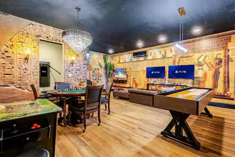 Egyptian-themed games room with PS5, pool table and arcade